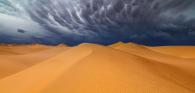 Sand dunes with stormy sky