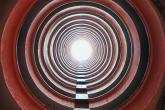 Looking through a long tunnel towards a bright light.