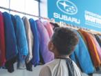 child looks at coats