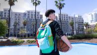 Person with a colorful "Project UP" backpack holding a basketball
