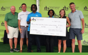 People posing with an oversized check
