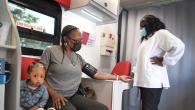 Patient shown with her daughter having her blood pressure checked.