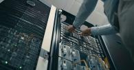Technician installing server components inside a data center, supporting cloud computing and AI infrastructure.