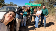 group photo on side of the road by car