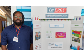Henkel employee with an EmERGE poster