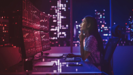 Person looking up at several monitors