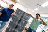 Two volunteers next to large boxes