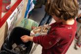 child recycling a carton