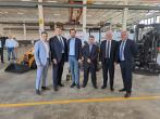 6 people standing together in a factory