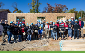 A group of volunteers outside a home being built