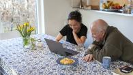 Young woman seated at a table with an older man.