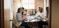 4 people sitting at a meeting