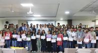 students holding up their certificates
