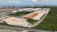 Aerial view of the Port of Caucedo and existing economic zone in the background, with cleared land in the foreground marking the site of DP World’s planned expansion.