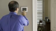 Someone adjusting a thermostat