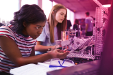 Students working on a machine