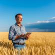 person standing in a field with a computer
