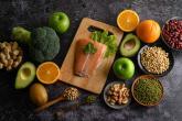 Legumes, vegetables and fruits shown on a cutting board.