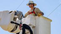 A line-worker in a bucket-lift near power lines
