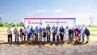Group of people in hard hats with ceremonial shovels of dirt