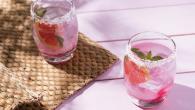 two sugar-rimmed glasses of a pink drink