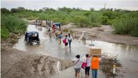 Doctors walk or are transported on a truck after attending to a medical volunteer campaign supported by local health organization Vida Peru, with medical aid from Direct Relief, during flooding from the 2017 El Niño events in the country. (Photo by Enrique Castro-Mendivil for Direct Relief)