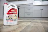 example of new packaging showing container of Home Defense on the floor of a kitchen