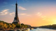Eiffel Tower with a setting sun to the side.