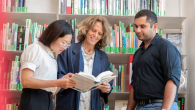 Three people reading a book