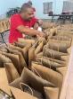 Bacardi employee filling bags