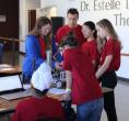 A group of youth and adults working on a robot.
