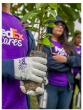 Close up of a volunteer holding a plant.