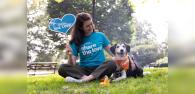 Person wearing "Subaru share the love event" shirt sitting next to a dog