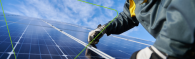 Close up of a person installing a solar panel.