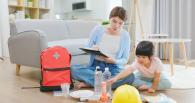 Mother and child checking emergency supplies off a list