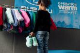 child looking at new clothes