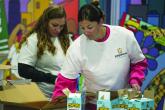 Two people in white t-shirts handling boxes