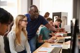 teacher and students on computers