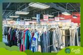 Racks of clothing on hangers. A green border and Earth Week logo in the corner.