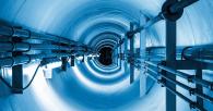 A tunnel with groups of long wires bundled on the sides.