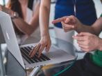 people's hands in front of laptop