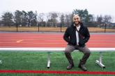 person sitting on a bench at a track