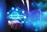 person holding a drawing of an orb with word "INNOVATIONS"