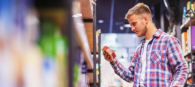 A customer looking at a product from a shelf