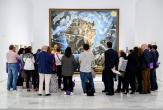 A small crowd admiring a large painting
