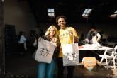 Two event participants pose with Portola-branded tote bags during the College Connection Program.