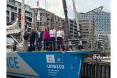 People standing on bow of ship