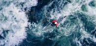 Kayak shown in rough waters.