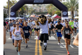 LA Kings Mascot Bailey running with arms pumped up aside runners