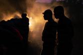 group of people standing in the dark with one light